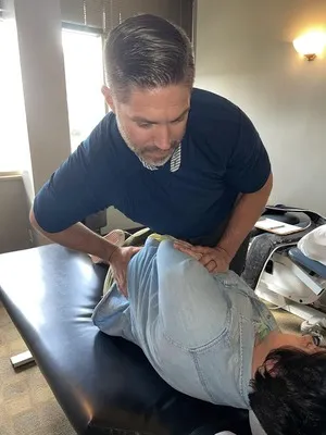 Chiropractor St Louis Park MN Travis Gilbertson Adjusting Shoulder